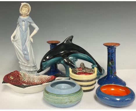 A large Poole pottery dolphin; a Nao by Lladro figure, Lady with Bonnet and Scarf; a pair of torquey ware candlesticks; a CH 