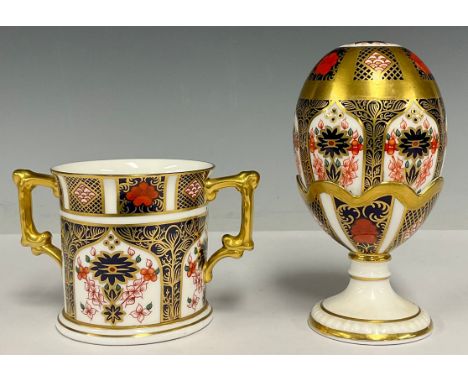 A Royal Crown Derby 1128 Imari pattern egg and stand, solid gold band, 13cm high, second quality, no button; a 1128 pattern l