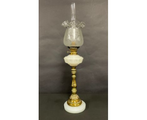 A late 19th/early 20th century oil lamp, faceted opaque glass font, brass baluster column, opaque glass circular base, froste