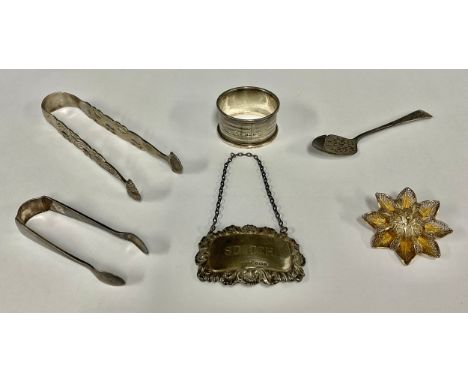A pair of George III silver sugar tongs, pierced tines, shell tips, probably  Thomas Wallis I, London c.1780;  napkin ring, S