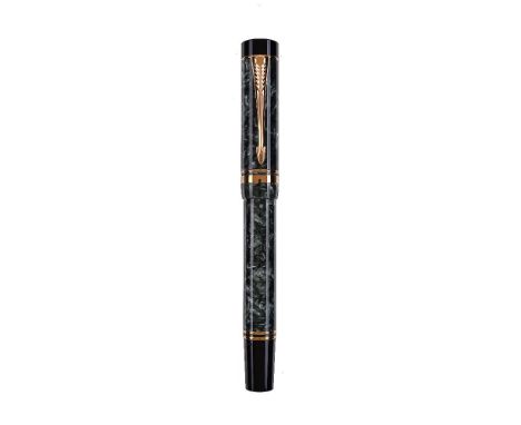 Parker, Duofold, a green marbled fountain pen, the cap with gilt arrow clip and double cap band, the medium nib stamped 18K 7