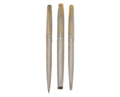 Parker, 75, a white metal fountain pen, ballpoint pen and propelling pencil, with engine turned decoration and gilt arrow cli