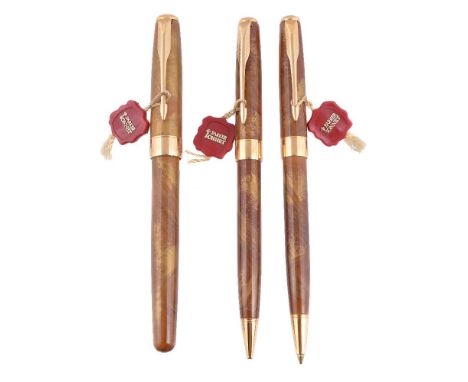 Parker, Sonnet, an ambre Chinese lacque fountain pen, ball point pen and propelling pencil, the fountain pen with gilt arrow 
