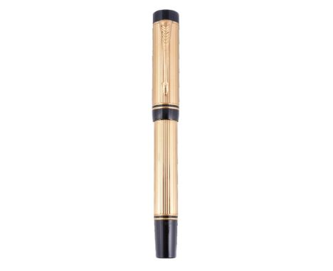 Parker, Duofold Centennial, a gold plated fountain pen, the cap with arrow clip, the medium nib stamped 18K 750, cartridge fi
