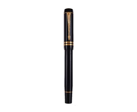 Parker, Duofold, a black fountain pen, the cap with gilt arrow clip and double cap band, the nib stamped 18K 750, cartridge f