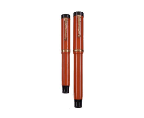 Parker, Duofold Lucky Curve, an orange fountain pen, the cap with gilt clip and cap band, button filling system; Parker, Duof