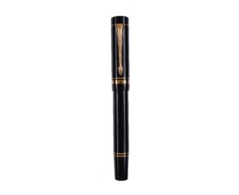 Parker, Duofold, a black fountain pen, the cap with gilt arrow clip and double cap band, the medium nib stamped 18K 750, cart