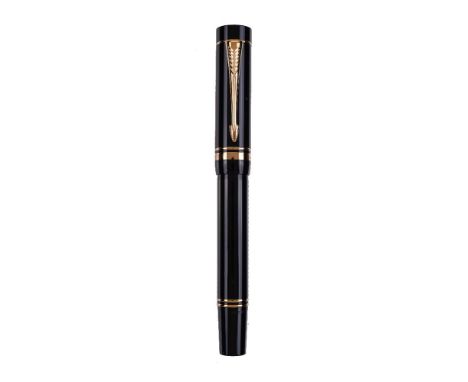 Parker, Duofold, a black fountain pen, the cap with gilt arrow clip and double cap band, the medium nib stamped 18K 750, cart