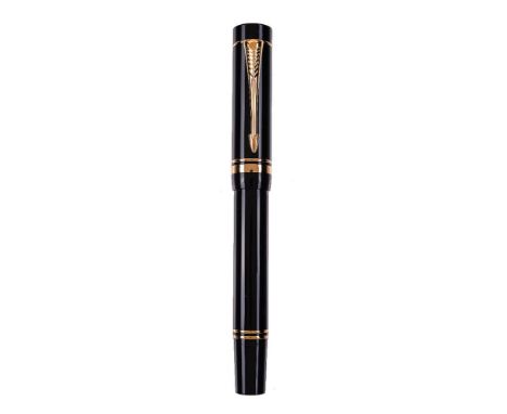 Parker, Duofold, a black fountain pen, the cap with gilt arrow clip and double cap band, the medium nib stamped 18K 750, cart