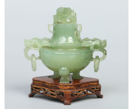 A Chinese jade censor and cover raised on a hardwood plinth. With a dog of fo finial to the domed cover and a pair of mythica