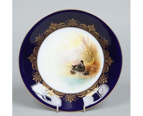 A Royal Worcester cabinet plate by George Johnson. Painted under a cobalt blue and gilt border with water foul. Printed puce 