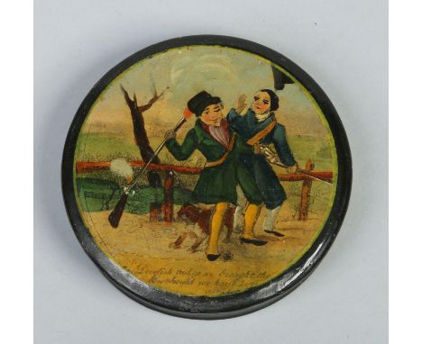 A Victorian circular lacquered papier mache snuff box. Printed and enamelled to the cover with a titled scene, 'Devilish luck