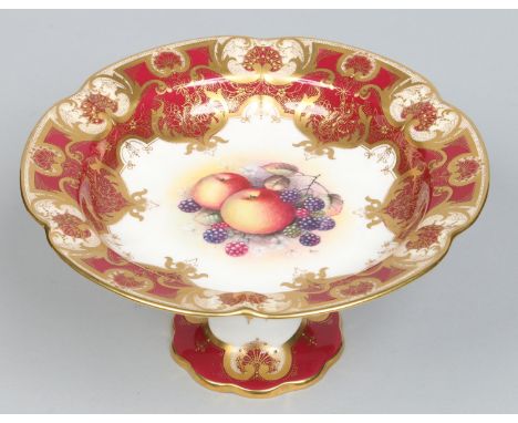 A Royal Worcester comport with claret ground borders ornamented with raised gilding. Painted to the centre with apples and bl