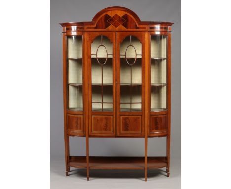 A Victorian mahogany large bow front display cabinet. Astrigal glazed, with satinwood banding and raised on square tapering s