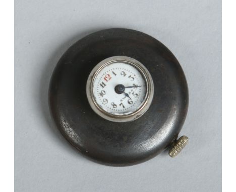 A vintage gun metal manual lapel watch with enamel dial. Reverse button 28mm diameter.   Condition Report. To be used as a gu