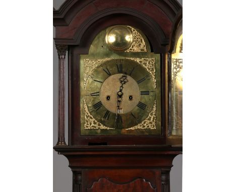 A George III mahogany eight day longcase clock. With brass arch top dial incorporating a chapter ring with black enamel marke