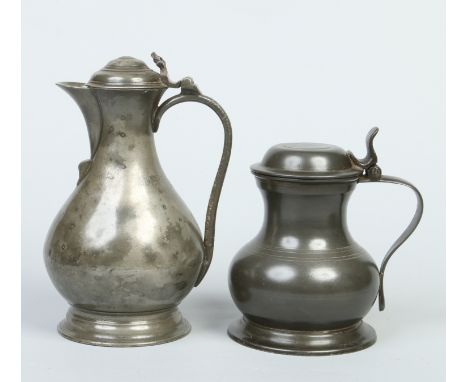 An 18th century pewter baluster shaped wine ewer with stepped domed cover along with a Bush & Perkins pewter measure. Largest