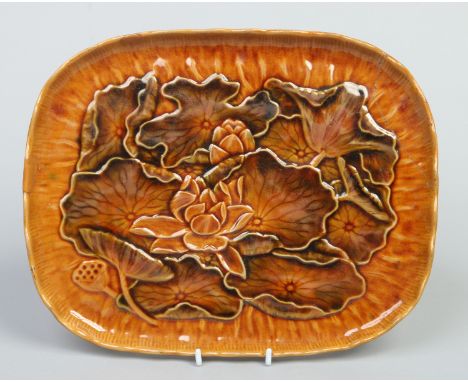 An Aesthetic Linthorpe pottery tray designed by Dr. Christopher Dresser. Decorated in brown glazes and moulded with stylized 