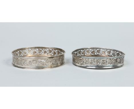 A pair of antique Continental silver wine coasters pierced with vine work to the sides. Punch marks, 820, 194 grams, 12.5cm d