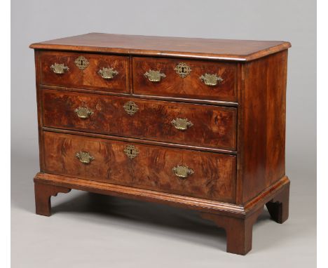 An early 18th century walnut chest of two over two drawers. Feather banded and raised on bracket feet, 1m 3cm wide.    Condit