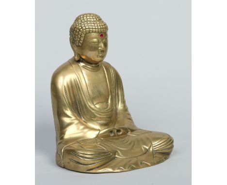 An Oriental brass model of a seated meditating Buddha set with a red stone bindi, 34cm.   Condition Report. To be used as a g