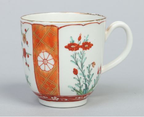 A Worcester coffee cup with grooved loop handle. With a scarlet Japan type pattern with panels of Kakiemon flowers between gi