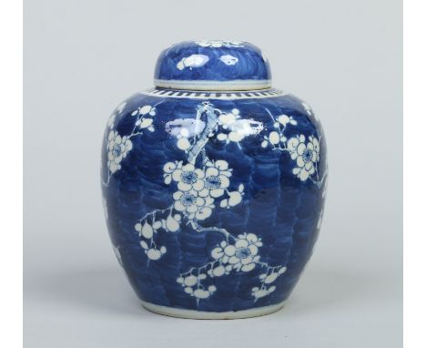 A 19th century Chinese Kangxi style ginger jar and cover. Decorated in underglaze blue with prunus blossom. Two concentric ri