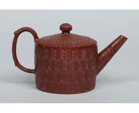 A late 18th century Staffordshire glazed red stoneware teapot and cover. With incised decorations and acanthus moulded handle