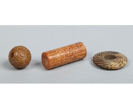 A Chinese small carved jade bi disc and two archaic style beads. Disc 4cm diameter.   Condition Report. To be used as a guide