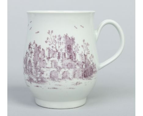 A Worcester bell shaped mug with reeded strap handle. Enamelled in puce camaieu to depict landscape scenes with ruins, 11.5cm