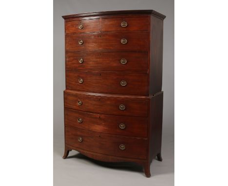 A George III mahogany bow front chest on chest. With oval lacquered brass handles, ebony banding and raised on splay bracket 