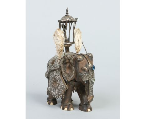 An Indian carved hardwood model of an elephant with silver howdah, 23cm.