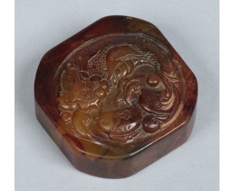 A Chinese carved hardstone scholars seal of canted square form. Decorated to the top with a roundel containing fish, the matr