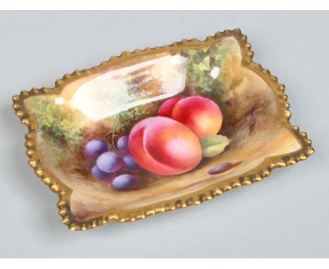 A Royal Worcester pin dish with shaped gardrooned edge by George Moseley. With gilt rim and painted with peaches and grapes. 
