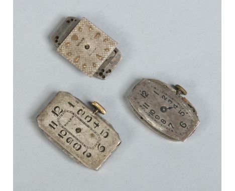Three vintage Rolex watch movements. 