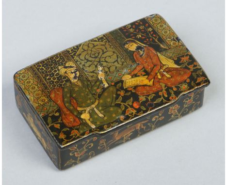 A 19th century Persian lacquered papier mache snuff box painted with a pair of seated figures, 8.5cm wide.   Condition Report