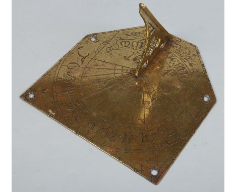 A 19th century brass sundial with open fretwork gnomon, engraved with dolphins, inscribed Mors Venit and spuriously dated 167