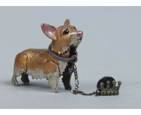 A novelty cold painted silver brooch in the form of a corgi with safety chain having crown shaped pin. Assayed London 2005, 2