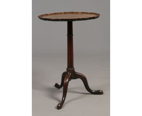 A Chippendale period mahogany centre pedestal wine table. With scalloped dish top, raised on a cluster column over carved cab