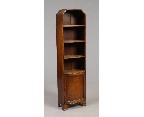 A George V oak bow fronted bookcase of slender proportions and with a single cupboard base, 1m 54cm high, 41cm wide.   Condit