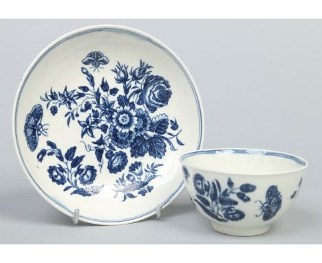 A Worcester tea bowl and saucer. Printed in underglaze blue with the Three Flowers pattern. Hatched crescent marks, c1775, sa