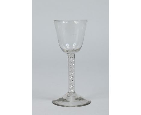 A late 18th century wine glass with plain bowl raised on a helix airtwist stem, 17cm.   Condition Report. To be used as a gui