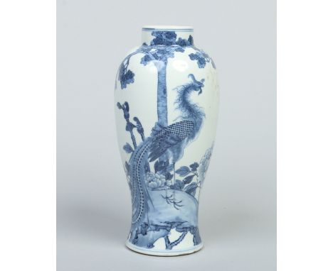 A Chinese Kangxi style baluster vase. Decorated in underglaze blue with a phoenix stood on a grassy mound surrounded by bloom