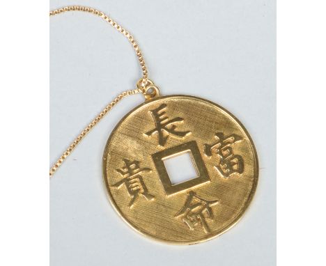 A Chinese 14 carat gold medallion on an 18 carat gold chain. Formed as a bi disc and eatch side with a textured ground adorne