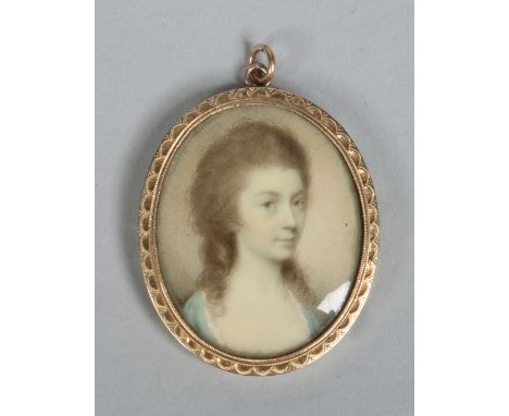 An early 19th century ivory portrait miniature of a woman in yellow metal mount, 4.5cm high.   Condition Report. To be used a