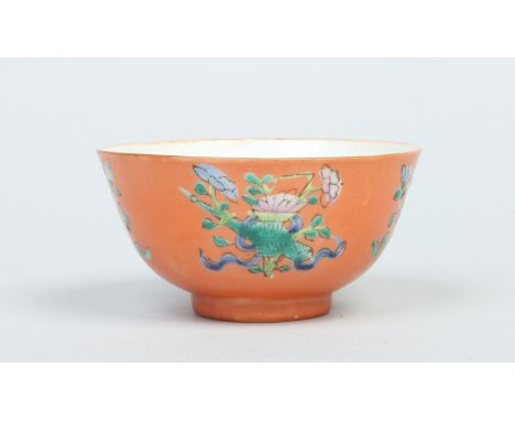 A Chinese Tongzhi (1862-1874) tea bowl. Orange ground and decorated in famille verte enamels with plants and a carp to the in