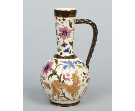 A Zsolnay ewer with ropetwist handle and decorated with stylized flowers and rampant lions, 20.5cm.    Condition Report. To b