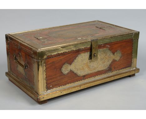 A 19th century Indian hardwood trunk. Brass mounted and with engraved decoration, 60cm wide.