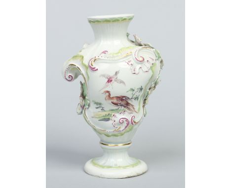 A rare large Derby Rococo moulded pedestal vase with applied flowers. Edged in turquoise enamel heightened in gilt and puce a