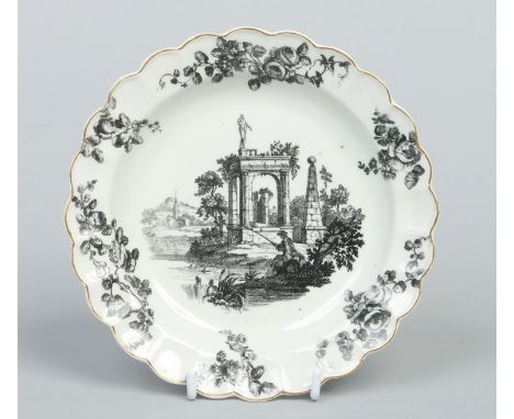 A Worcester small lobed plate with gilt rim. Decorated with a black onglaze transfer print after Robert Hancock with a man fi